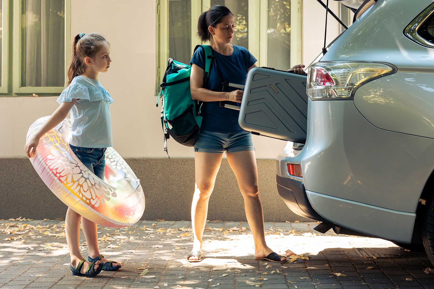 Mother and small child near a car